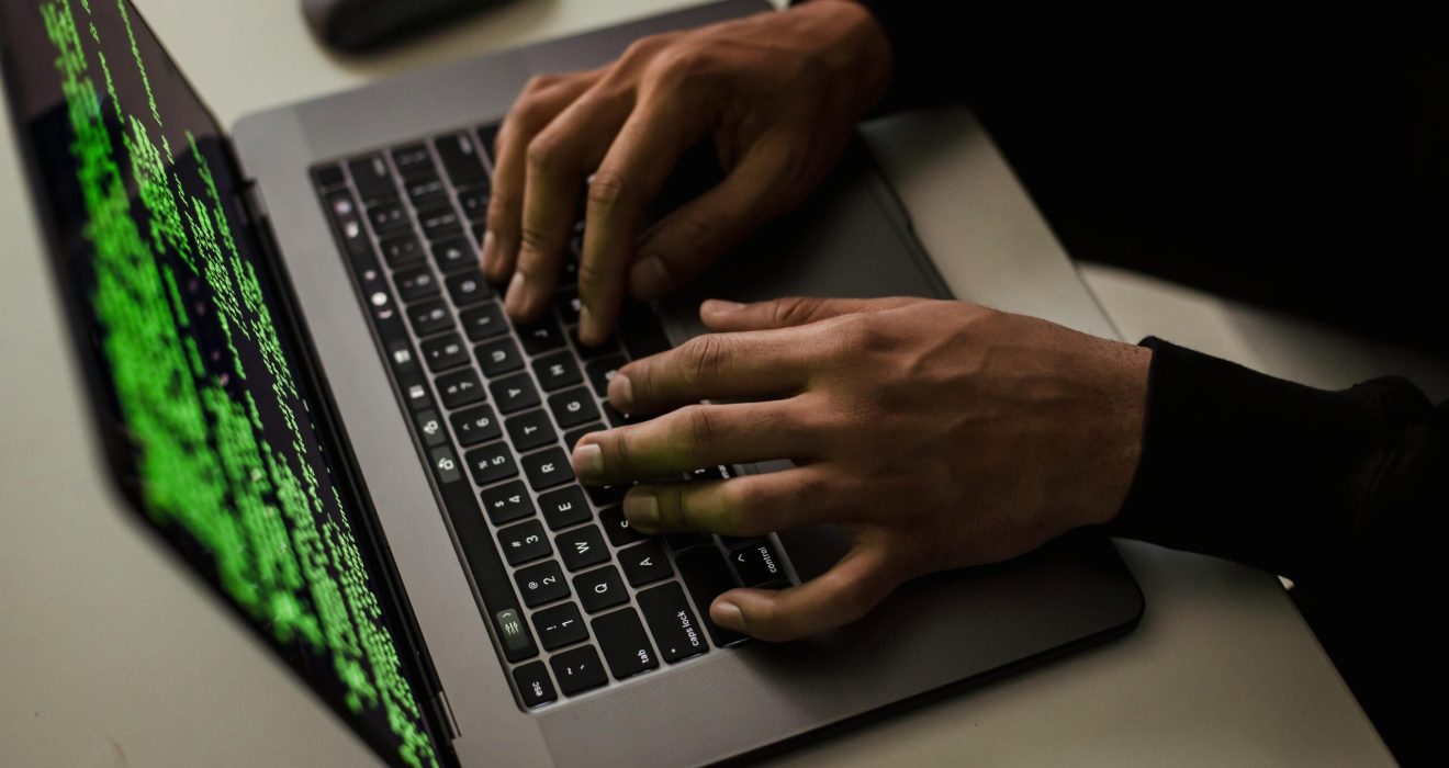 crop-cyber-spy-hacking-system-while-typing-on-laptop