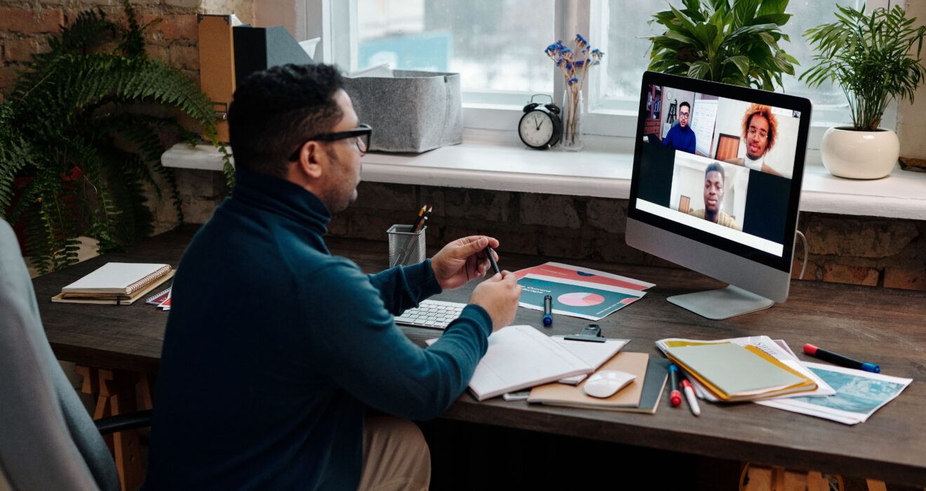 teacher-video-calling-with-his-students-using-a-computer